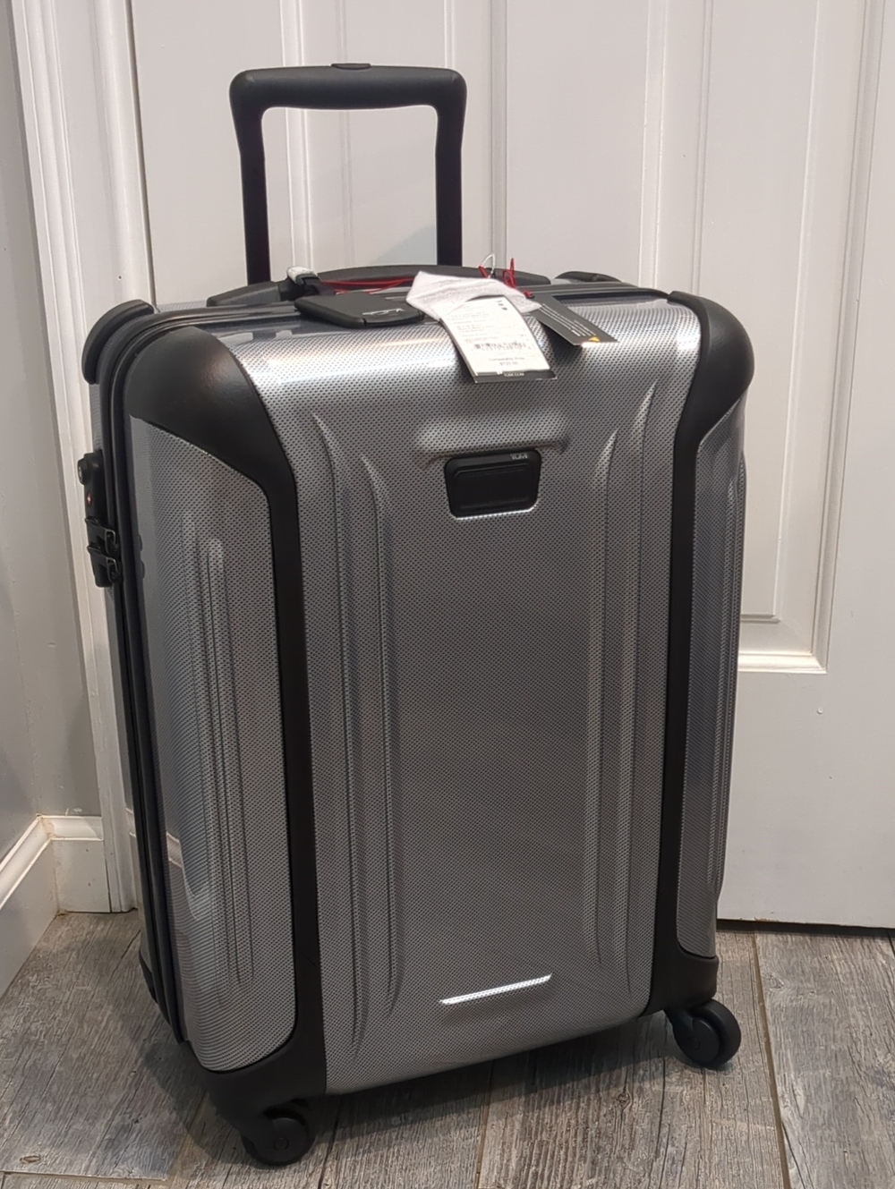 TUMI/ Continental Carry On Silver Hard-Shell Rolling Luggage